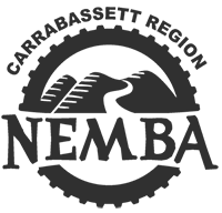 Single color logo for Carrabassett Region NEMBA (CR NEMBA) featuring mountains and a bike trail surrounded by a bike tire and the words: Carrabassett Region NEMBA.
