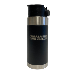 Photograph of black, insulated travel mug with a black lid. There are silver-colored bands around the top and bottom. Carrabassett Coffee Company is written across the center of the mug.