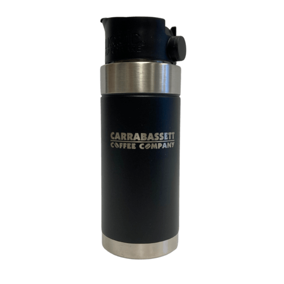 Photograph of black, insulated travel mug with a black lid. There are silver-colored bands around the top and bottom. Carrabassett Coffee Company is written across the center of the mug.
