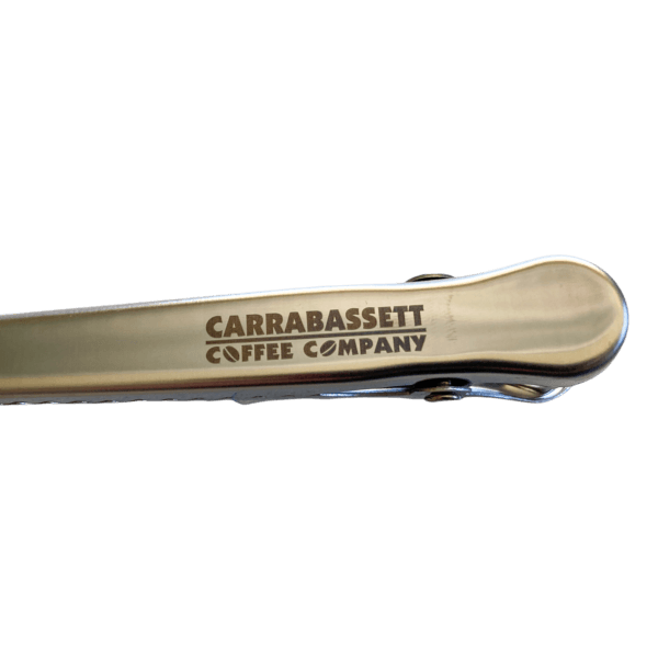 Close up detail of the clip-side of the handle, where the words: "Carrabassett Coffee Company" are embossed.