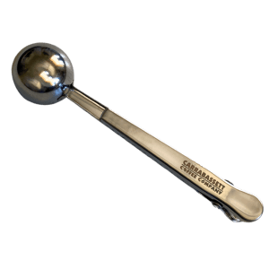 Stainless steel coffee scoop with a clip on the handle end. The words: "Carrabassett Coffee Company" are embossed on the handle.