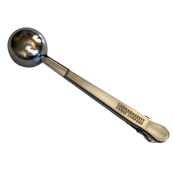 Stainless steel coffee scoop with a clip on the handle end. The words: "Carrabassett Coffee Company" are embossed on the handle.