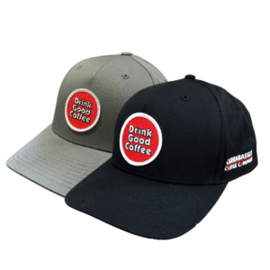 Two hats- one gray and one black with the drink good coffee round logo patch on the front.