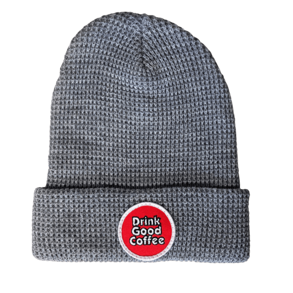 Light Gray waffle knit beanie winter hat with folded brim and round, red, logo patch embellishment. The patch reads: "Drink Good Coffee" in white.