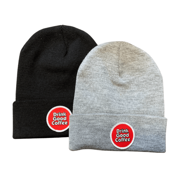 Two tight knit beanie hats with the drink good coffee circle logo on the front. Pictured are black and gray.