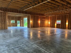 internal view of the addition to the coffee company building, showing the studs and concrete floor