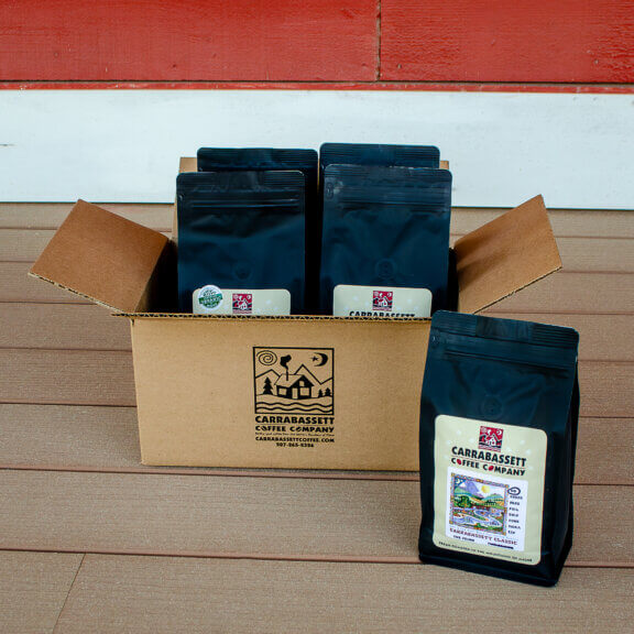 A box of Carrabassett Coffee bags on a porch