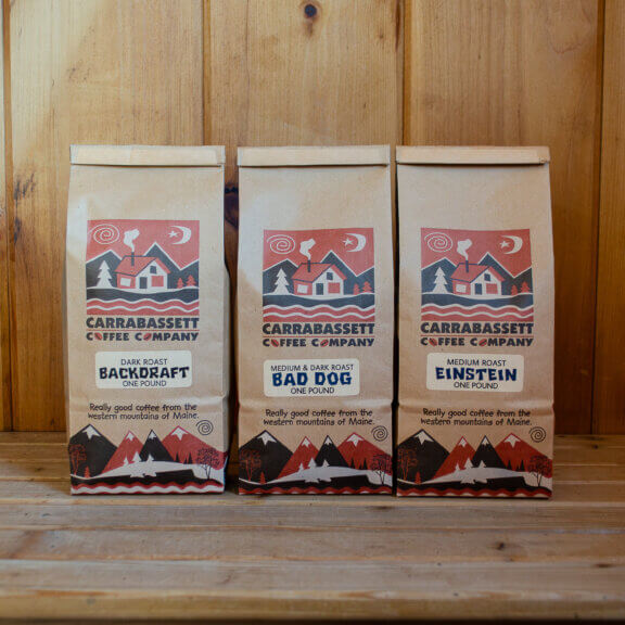 Three one pound bags of coffee in the entryway of Carrabassett Coffee Company