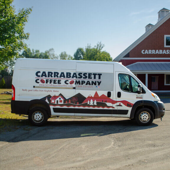 The Carrabassett Coffee Company delivery van in front of the Carrabassett Coffee Company Building
